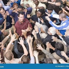A well-known person being recognised by an admiring crowd.