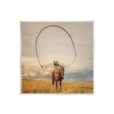 A cowboy using a looped rope as a lasso