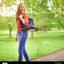A person walking leisurely along a park path.