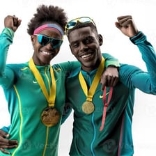 An athlete celebrating a first-place victory with a gold medal