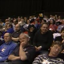 An audience booing during a theatrical performance