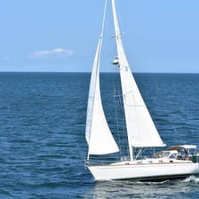 A sailing boat underway in open water.