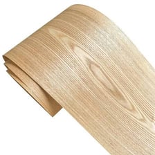 A thin sheet of wood veneer covering a furniture surface.