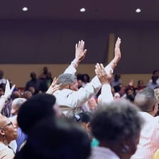 People engaged in worship inside a place of worship