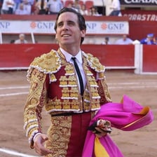 A matador in traditional costume in a Spanish bullfighting ring.