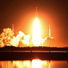 A rocket rising from its launch pad at liftoff
