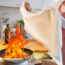 A flame being covered to extinguish it