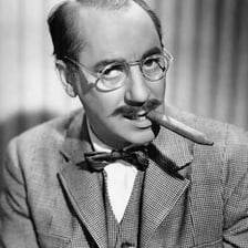 A portrait of comedian Groucho Marx with his characteristic moustache