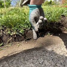 A person moving cautiously along a narrow ledge.