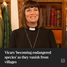 A Church of England vicar standing inside a parish church