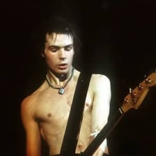Sid Vicious performing on stage with the Sex Pistols