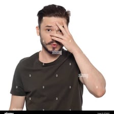 A person showing embarrassment by covering their face.