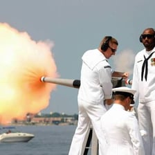 A ceremonial military gun salute being fired