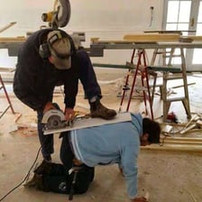 A worker employing a tool in a workplace