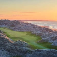 A coastal links golf course with dunes and fairways.