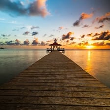 A pier projecting from a beach into the sea