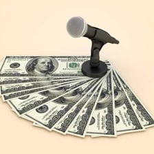 Cash beside a microphone used for recording a podcast.