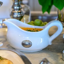 A gravy boat placed on a dining table