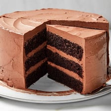 A slice of rich layered torte on a plate.