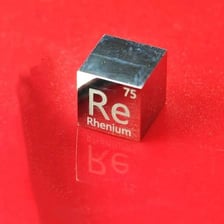 A sample of rhenium metal beside its chemical symbol