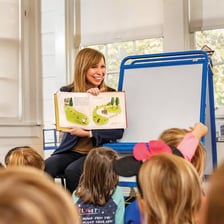 A teacher reading an educational publication.