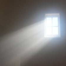 A visible beam of sunlight passing through a window
