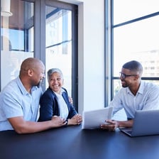 A consultant discussing advice with a client across a desk