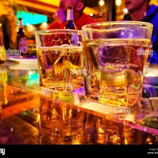 Several alcoholic and non-alcoholic drinks arranged on a pub table.