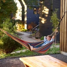 A person lounging idly in a hammock.
