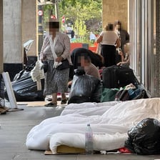 A person sleeping outdoors on a city street