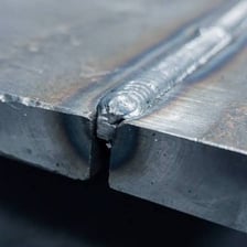 A close-up of a fused metal joint showing the raised bead of a weld.