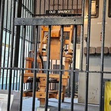 A prison warder standing in a historic dungeon