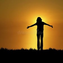 A smiling person looking toward a bright sunrise, representing optimism.
