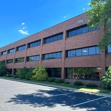A modern corporate office building representing a holding company.