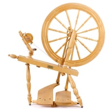 Thread being spun on a spinning wheel.