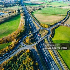 A divided road with two carriageways carrying traffic in opposite directions.
