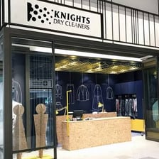 A dry-cleaning shop with garments displayed or awaiting collection.