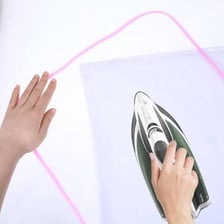 Hands pressing a piece of fabric with firm pressure.