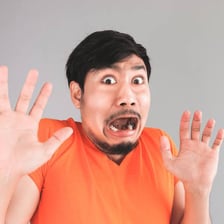 A person reacting fearfully to something frightening.