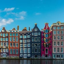 A canal lined with characteristic narrow houses in Amsterdam.