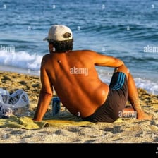 A person relaxing in warm sunlight on a beach