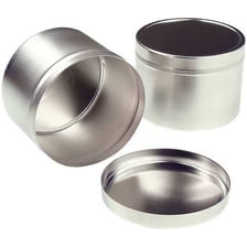 A tin can beside a sample of tin metal