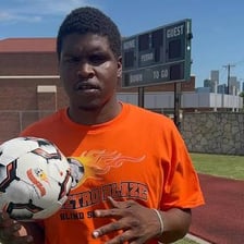 An athlete holding a ball during a sporting activity.