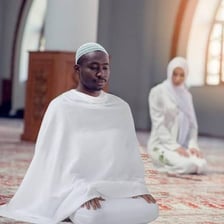 A Muslim pilgrim wearing the simple white garments used for ihram.