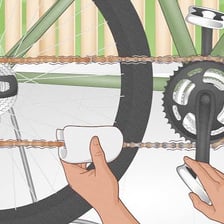 Lubricating oil being applied to a bicycle chain.