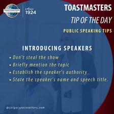 A toastmaster speaking at a formal dinner while introducing guests.
