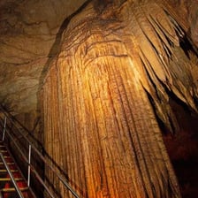 A stalagmite rising from the floor of a limestone cave