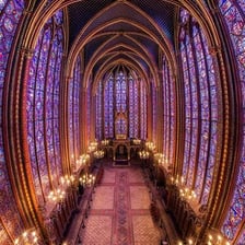 The interior of a large cathedral with stained-glass windows