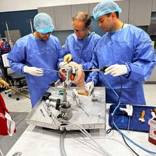 A surgical team performing an operation involving a bone.
