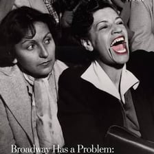 An actor laughing during a theatrical performance